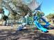 Modern playground with slides, climbing structures, and shade at 3390 Dover Dr, Punta Gorda, FL 33983
