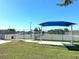 Outdoor tennis courts with shade structure and ample space at 3390 Dover Dr, Punta Gorda, FL 33983