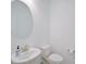 Small half bathroom with toilet, sink, and oval mirror at 4008 Via Sienna Cir, Sarasota, FL 34243