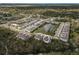 Aerial view showcasing a single townhouse in a community with a lake and surrounding homes at 4008 Via Sienna Cir, Sarasota, FL 34243