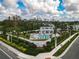 Community pool with a cabana, surrounded by lush landscaping and comfortable lounge chairs at 4008 Via Sienna Cir, Sarasota, FL 34243