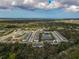 An aerial view of a townhouse community, highlighting a single unit near a pond at 4008 Via Sienna Cir, Sarasota, FL 34243