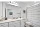 Clean bathroom with vanity, toilet, shower, and striped curtain at 4008 Via Sienna Cir, Sarasota, FL 34243