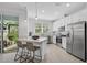 Modern kitchen with white cabinets, stainless steel appliances, and breakfast bar at 4008 Via Sienna Cir, Sarasota, FL 34243
