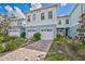 Two-story townhome with a paved pathway and lush landscaping at 4008 Via Sienna Cir, Sarasota, FL 34243