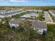 Aerial view of a community with lake, featuring multiple townhouses and lush landscaping at 4008 Via Sienna Cir, Sarasota, FL 34243