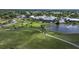 Aerial view of golf course, clubhouse, and surrounding landscape at 410 Cerromar S Cir # 141, Venice, FL 34293