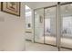 Hallway with mirrored closet doors and bathroom access at 427 Cerromar Ln # 456, Venice, FL 34293