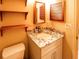 Clean bathroom with granite vanity and wood shelving at 4841 Marlin Rd, Venice, FL 34293