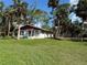 Single story home with red roof and white exterior walls, large grassy yard at 506 Kenwood Ave, Nokomis, FL 34275