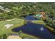 Aerial view of community with pool, golf course, and lake at 588 Sawgrass Bridge Rd, Venice, FL 34292