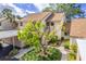 Exterior view of condo with stairs, landscaping, and carport at 688 Bird Bay Cir # 27, Venice, FL 34285