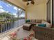 Relaxing lanai overlooking a canal, complete with seating and a floral rug at 900 San Lino Cir # 922, Venice, FL 34292