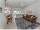 Open living room with light and airy feel, featuring a comfortable couch and access to a balcony at 900 San Lino Cir # 922, Venice, FL 34292