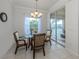 Elegant dining room with glass table and wicker chairs, adjacent to kitchen at 900 San Lino Cir # 922, Venice, FL 34292