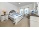 Spacious main bedroom with a king-size bed and a beautiful dresser at 900 San Lino Cir # 922, Venice, FL 34292