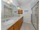 Double vanity bathroom with a large mirror and a walk-in shower at 900 San Lino Cir # 922, Venice, FL 34292