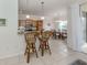 Kitchen breakfast bar with two stools, open to dining area at 900 San Lino Cir # 922, Venice, FL 34292