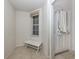 Bright entryway with a whitewashed bench and tiled floor at 900 San Lino Cir # 922, Venice, FL 34292