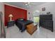 Bedroom with red accent wall and tiled floors at 1063 General St, Port Charlotte, FL 33953