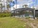 Screened pool and patio with grassy yard at 1063 General St, Port Charlotte, FL 33953