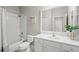 Bathroom with tub, toilet, vanity, and mirror at 12261 Stuart Dr, Venice, FL 34293