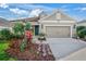 House exterior with landscaping and a two-car garage at 12261 Stuart Dr, Venice, FL 34293