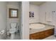 Convenient bathroom with toilet and a large soaking tub at 147 Tampa Ave # 303, Venice, FL 34285