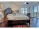 Spacious main bedroom with hardwood floors, king bed, and access to balcony at 147 Tampa Ave # 303, Venice, FL 34285