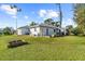 Spacious backyard with grassy lawn, garden and screened porch at 196 Stanford Rd, Venice, FL 34293