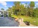 Large backyard with patio, garden planters and mature trees at 196 Stanford Rd, Venice, FL 34293