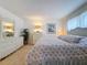 Main bedroom with floral bedding and white dresser at 210 Park N Blvd # 129, Venice, FL 34285