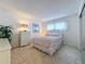 Bedroom with floral bedding, dresser, and carpet at 210 Park N Blvd # 129, Venice, FL 34285