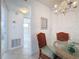 Bright dining area with glass table, chairs and chandelier at 210 Park N Blvd # 129, Venice, FL 34285