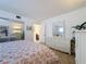 Well-lit bedroom featuring a mirrored dresser and floral bedding at 210 Park N Blvd # 129, Venice, FL 34285