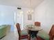 Small dining area with glass table and wicker chairs at 210 Park N Blvd # 129, Venice, FL 34285