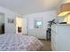 Bright bedroom with floral bedding and mirrored dresser at 210 Park N Blvd # 129, Venice, FL 34285