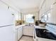 White kitchen features ample counter space and a window at 210 Park N Blvd # 129, Venice, FL 34285