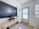 Entryway with a large TV and wicker media console at 210 Park N Blvd # 129, Venice, FL 34285