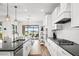 Modern kitchen with white shaker cabinets, granite counters, and a view of the pool at 26628 Irwin Dr, Englewood, FL 34223