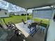 Covered patio offers shaded seating and views of the backyard at 370 Catamaran Ct, North Port, FL 34287