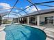 Large screened pool with surrounding patio and seating at 39 Long Meadow Ct, Rotonda West, FL 33947