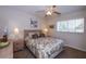 Bedroom with patterned bedding and ceiling fan at 408 Cerromar S Cir # 236, Venice, FL 34293