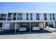 Exterior view of condo building with carport and parking spaces at 408 Cerromar S Cir # 236, Venice, FL 34293