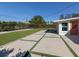 Landscaped backyard featuring concrete patio, green grass, and well-maintained hedges at 510 Harbor S Dr, Venice, FL 34285