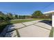 Spacious backyard featuring a modern concrete tile patio and pristine artificial lawn at 510 Harbor S Dr, Venice, FL 34285
