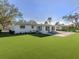 Green backyard with artificial turf and outdoor seating, perfect for relaxation at 510 Harbor S Dr, Venice, FL 34285