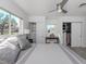 Bright bedroom with ceiling fan, closet storage, large windows and grey wood flooring at 510 Harbor S Dr, Venice, FL 34285