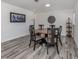 Open dining room featuring a round table, six chairs, and stylish decor at 510 Harbor S Dr, Venice, FL 34285