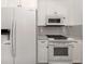 Bright kitchen with white appliances and cabinetry, creating a clean and modern look at 510 Harbor S Dr, Venice, FL 34285